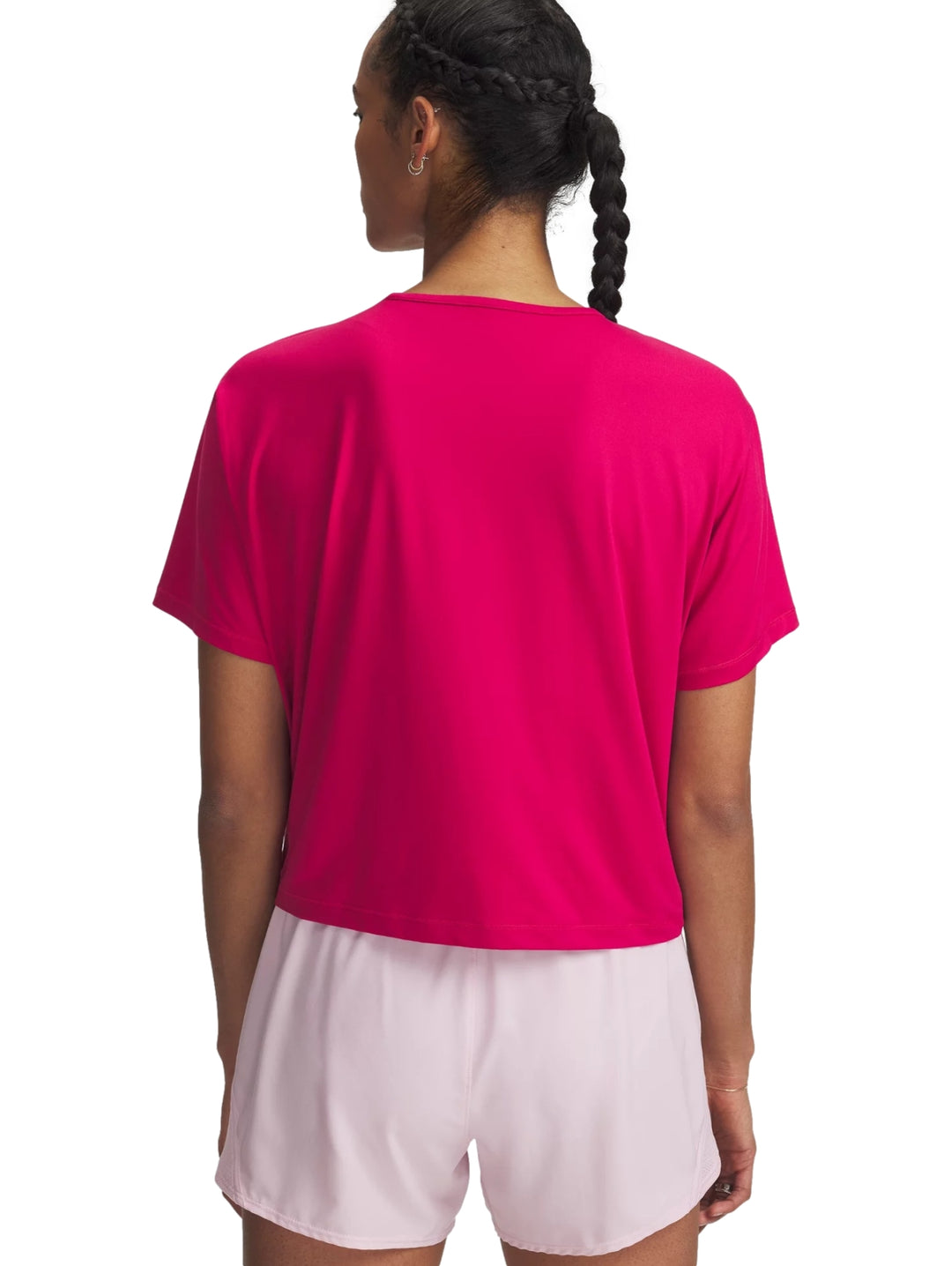 Mujer vistiendo una camiseta deportiva de manga corta color rosa intenso de la marca Under Armour.