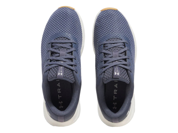 Tenis deportivos Under Armour color gris con suela blanca y base beige.