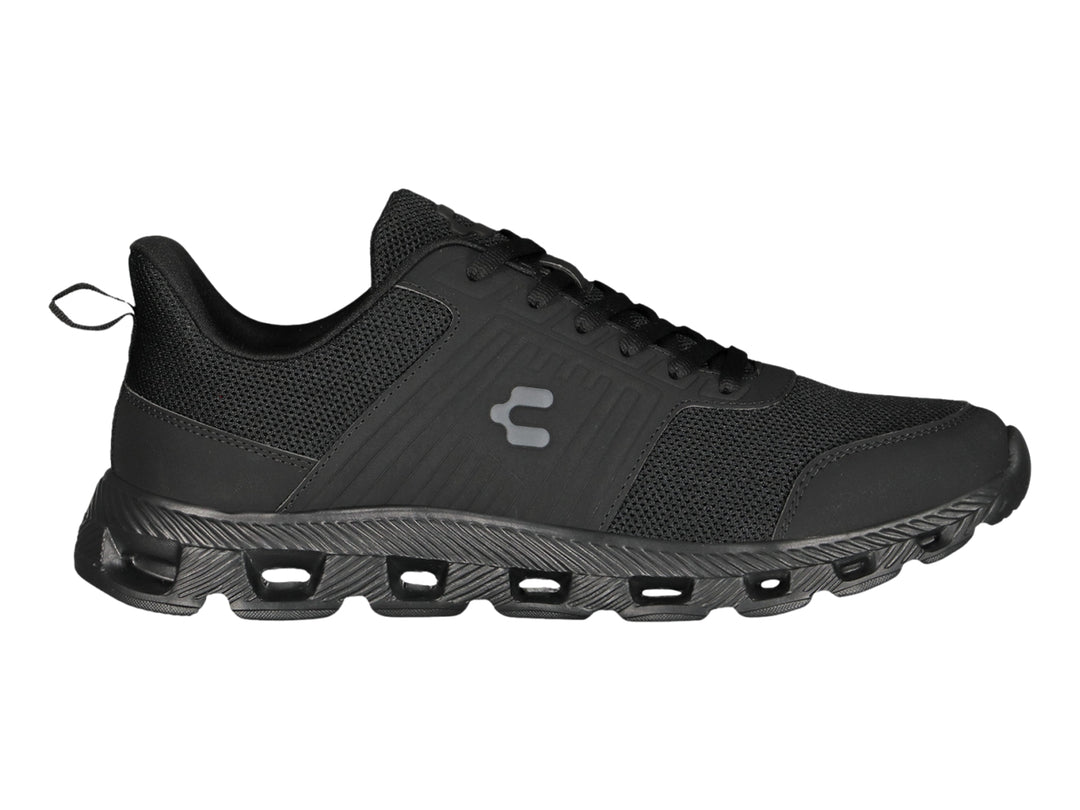 Tenis deportivos Charly color negro con suela texturizada y malla transpirable.