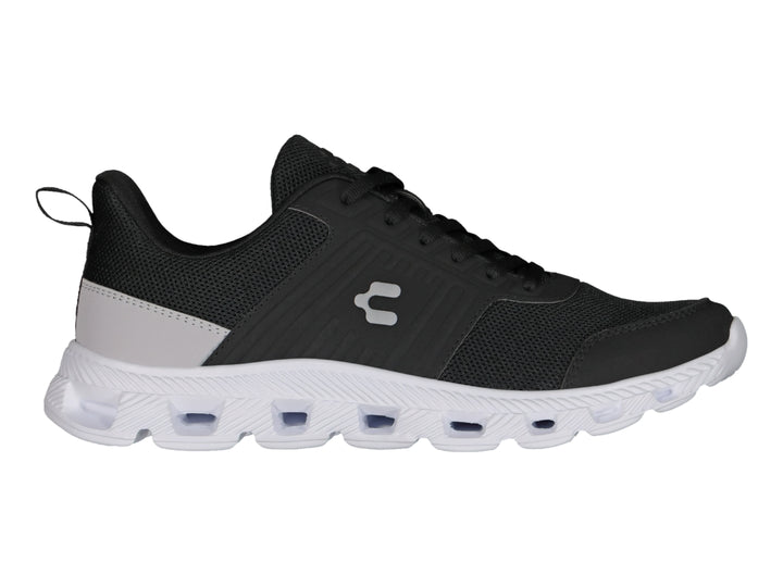 Tenis deportivos Charly color negro con suela blanca y detalle gris en el talón.