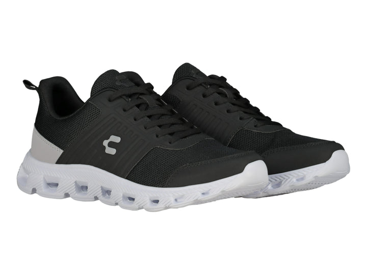 Tenis deportivos Charly color negro con suela blanca y detalle gris en el talón.