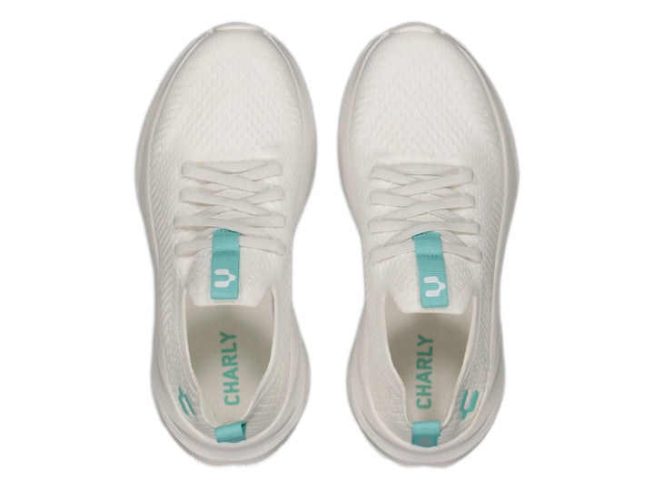 Tenis deportivos Charly color blanco con detalles en aqua, diseño de tejido ligero y suela blanca robusta.