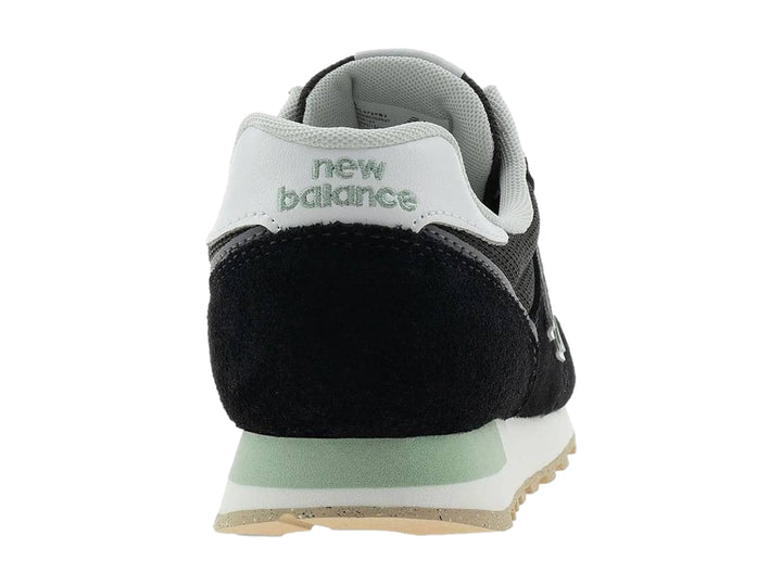 Tenis New Balance modelo 373 en color negro con detalles en blanco y gris, vista lateral.