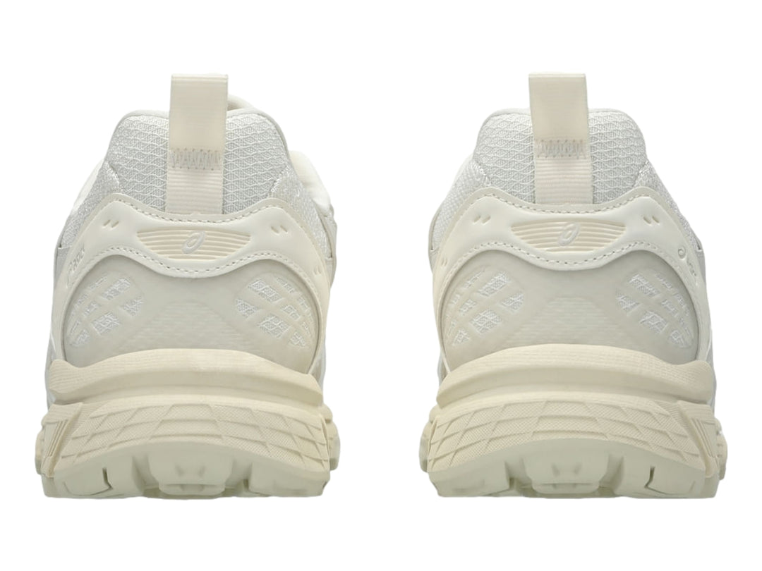 Tenis deportivos ASICS Gel-Nunobiki en color crema y plata con suela gruesa y detalles en malla.