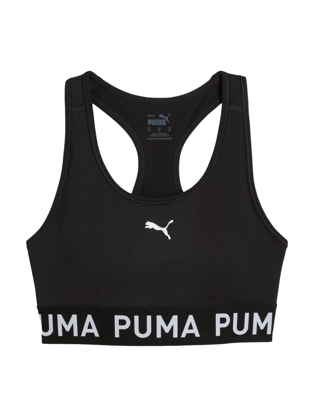Mujer usando un bra deportivo negro de PUMA sosteniendo un balón medicinal.