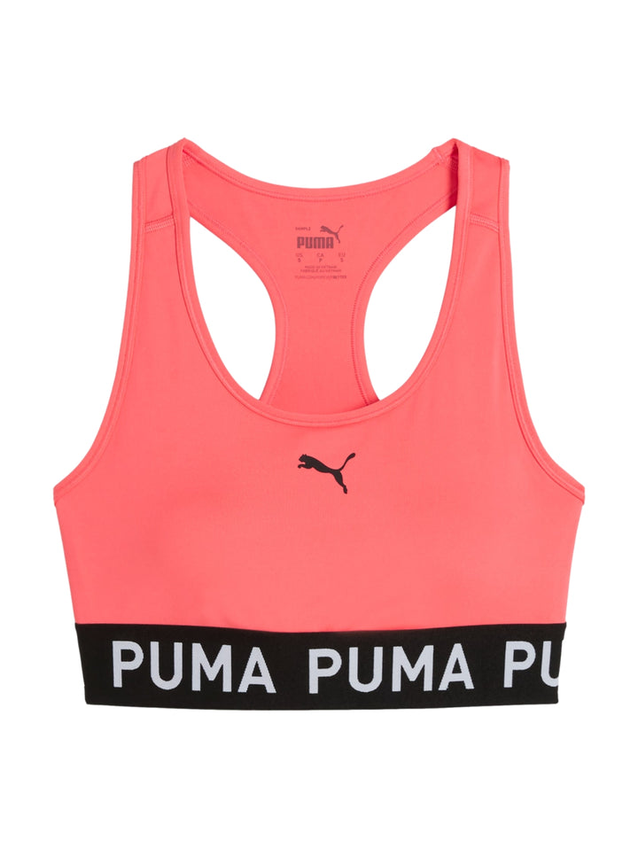 Bra deportivo PUMA color Peach Frost con banda elástica negra en la base y logo central.
