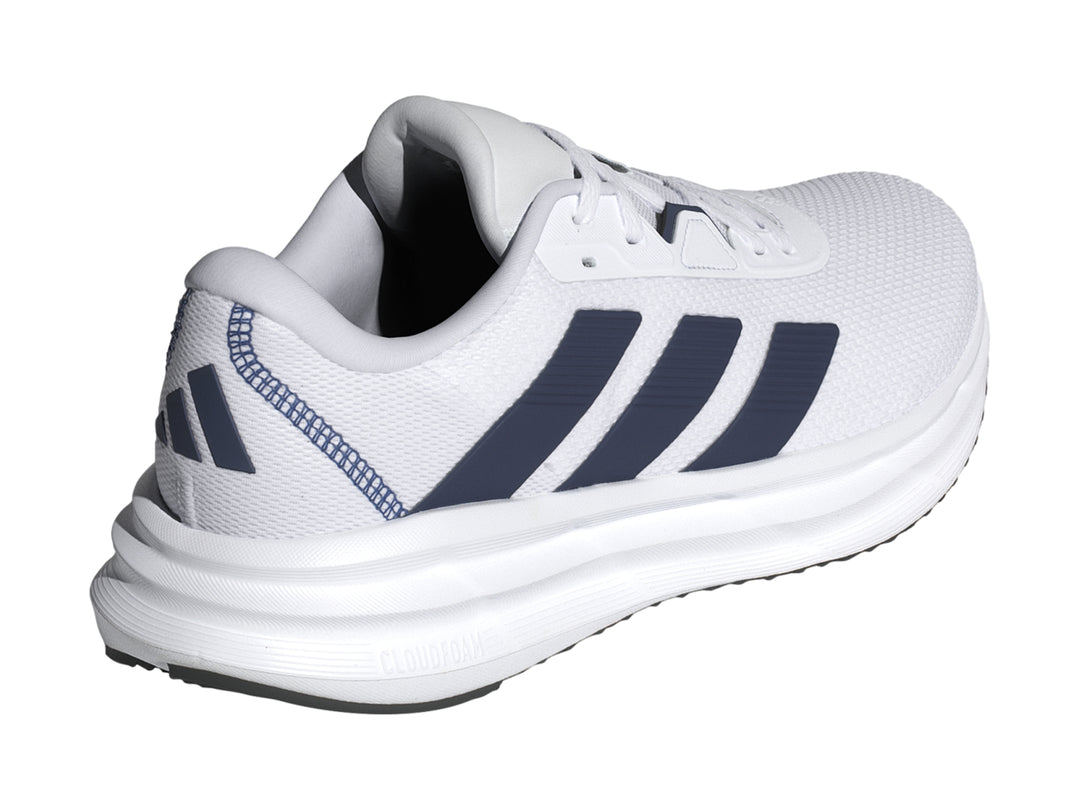 Tenis Adidas Galaxy 7 en color blanco con tres franjas azul oscuro y suela blanca amortiguada.