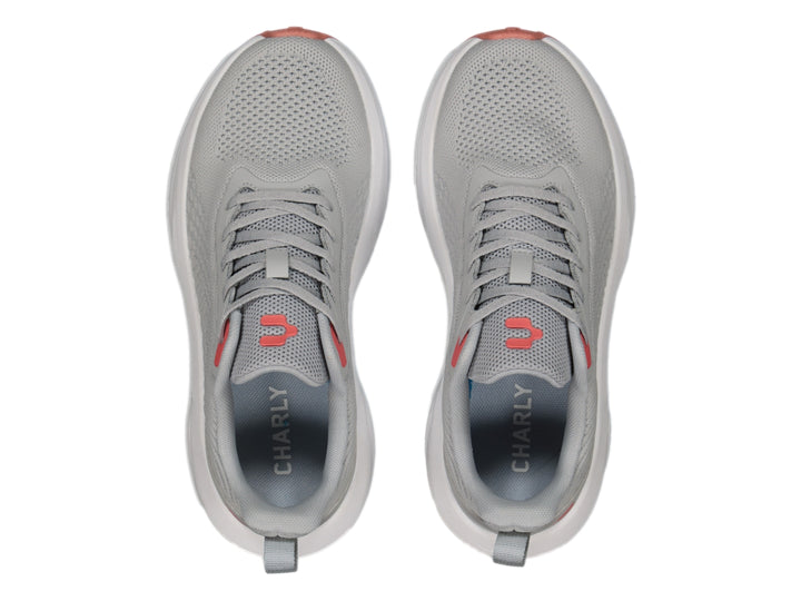 Tenis deportivos Charly color gris con suela blanca y detalles en rojo.