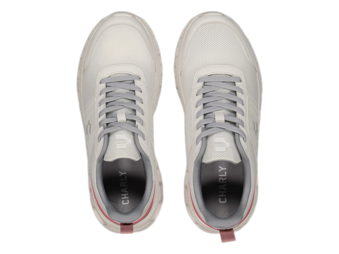 Tenis deportivos Charly color blanco con detalles en gris y rosa y suela blanca.