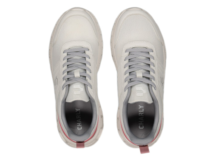 Tenis deportivos Charly color blanco con detalles en gris y rosa y suela blanca.