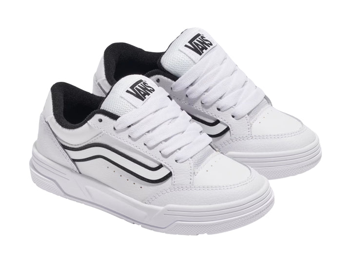 Tenis Vans blancos con franja lateral negra y suela blanca.