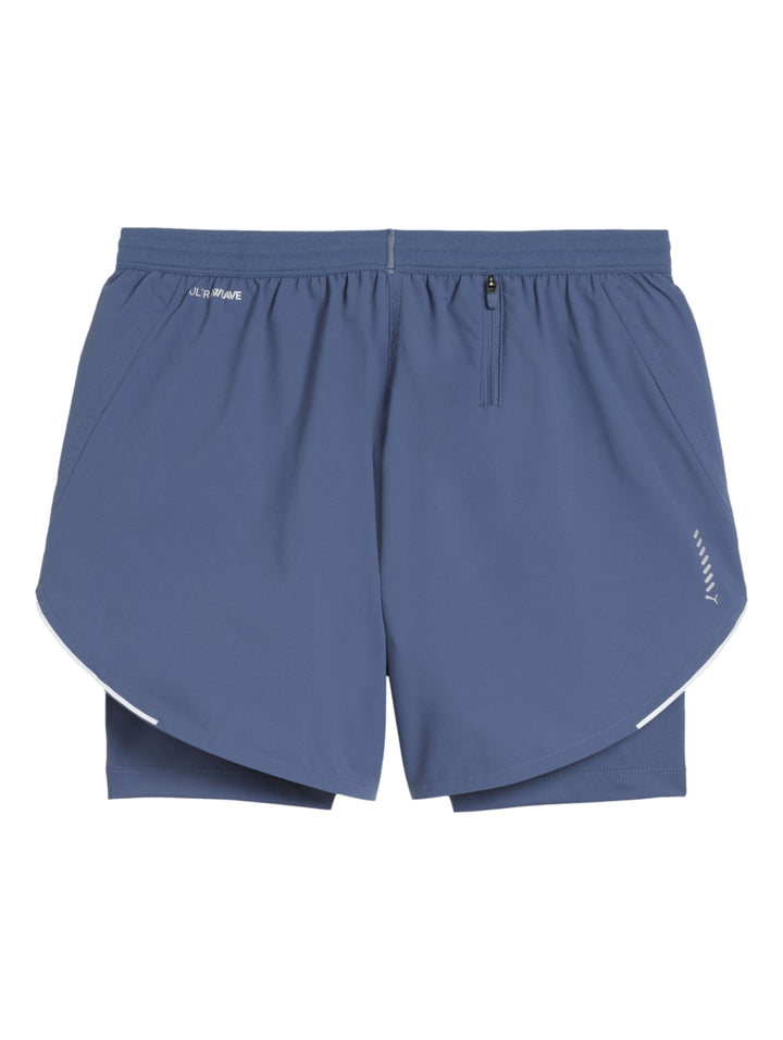 Shorts deportivos PUMA 2 en 1 color Dark Indigo para mujer, con diseño de doble capa y cintura ajustable.