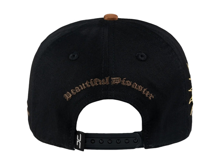 Gorra negra JC HATS con parche amarillo de carita feliz en el frente y detalle bordado lateral.