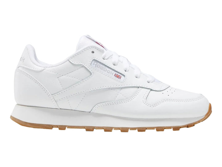 Tenis Reebok blancos de cuero con suela color café para niños.