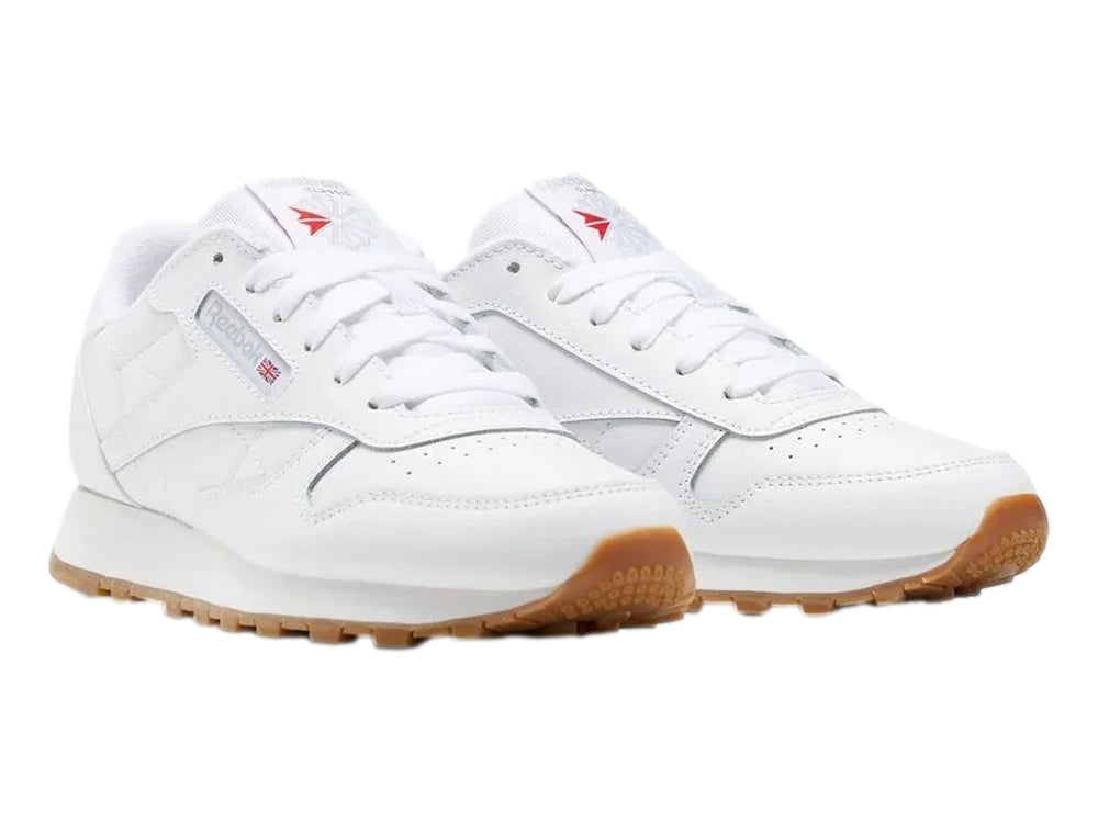 Tenis Reebok blancos de cuero con suela color café para niños.