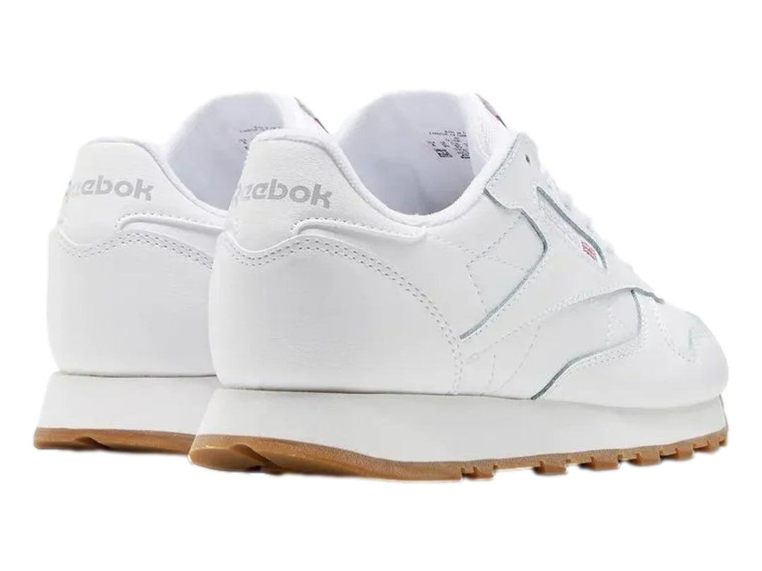 Tenis Reebok blancos de cuero con suela color café para niños.