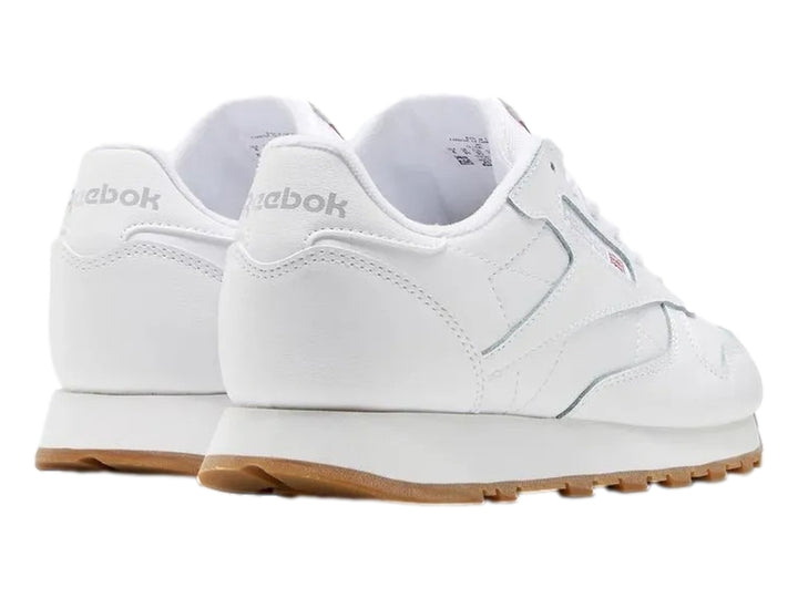 Tenis Reebok blancos de cuero con suela color café para niños.