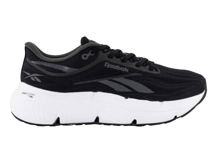 Tenis deportivos Reebok color negro con suela blanca y detalles laterales en gris.
