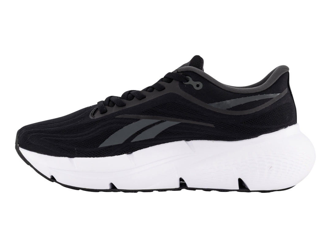 Tenis deportivos Reebok color negro con suela blanca y detalles laterales en gris.