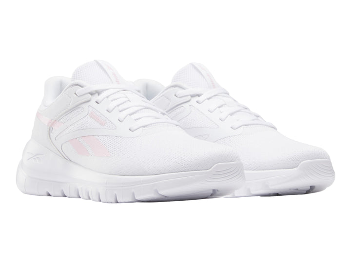 Tenis deportivos Reebok blancos con detalles en rosa claro, vista lateral.