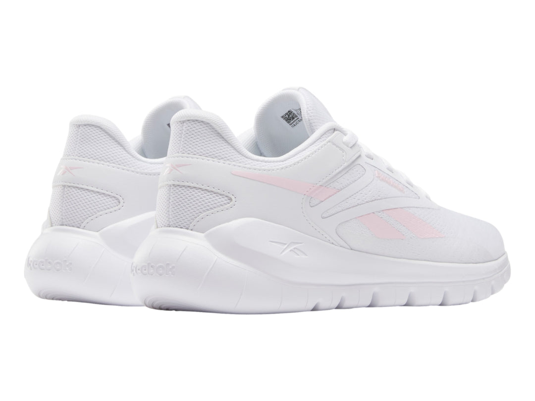 Tenis deportivos Reebok blancos con detalles en rosa claro, vista lateral.