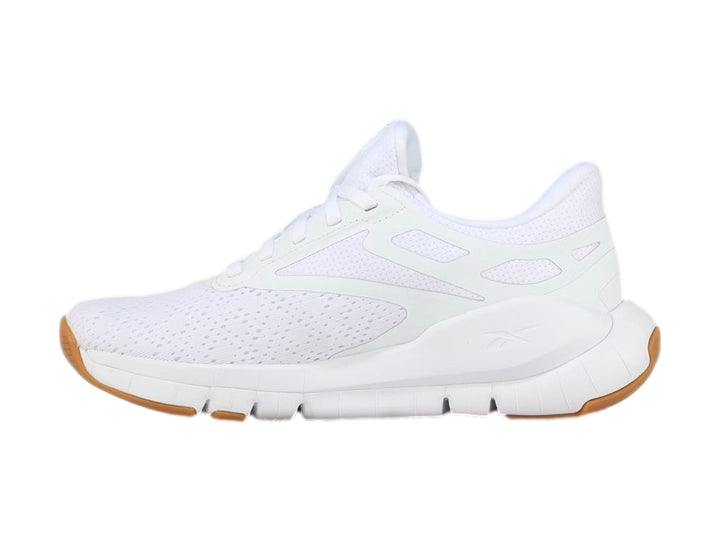 Tenis deportivos Reebok color blanco con suela de goma marrón.