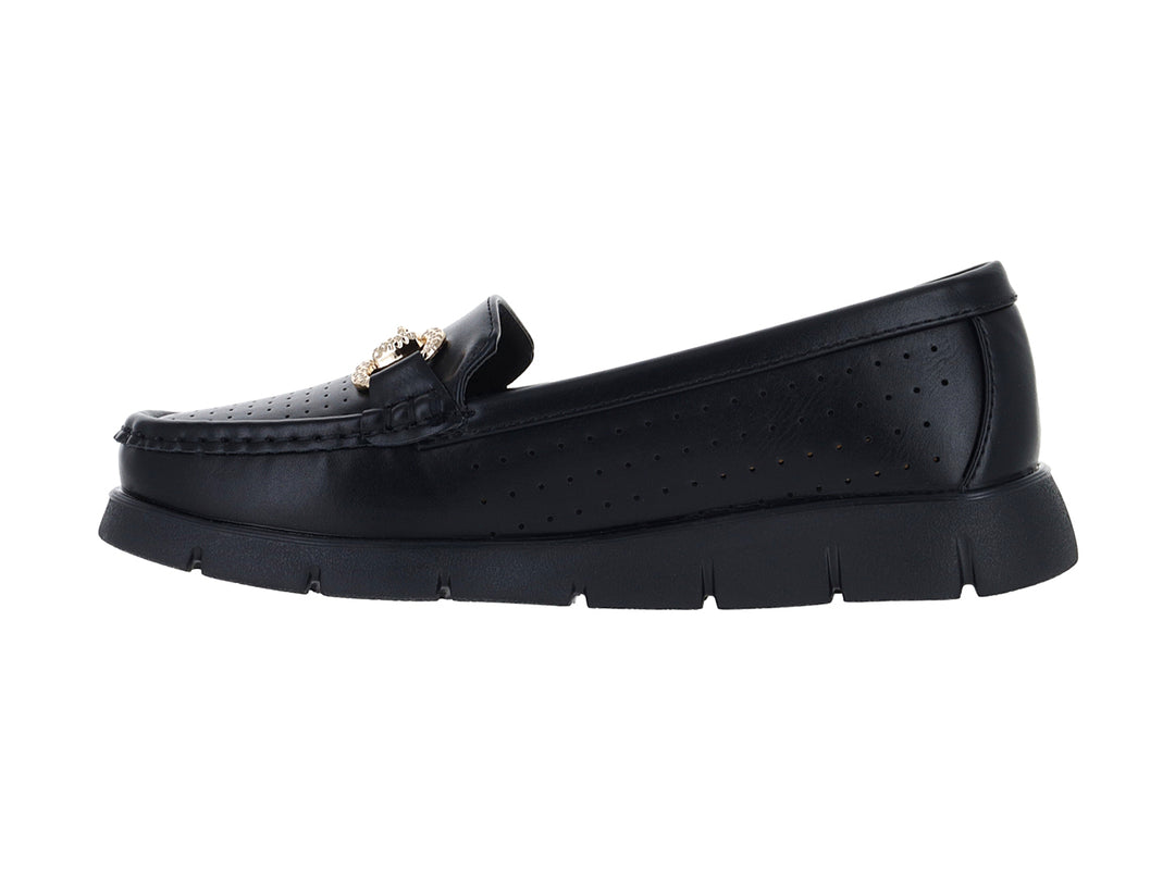 Zapato plano tipo mocasín color negro con adorno dorado y suela gruesa.