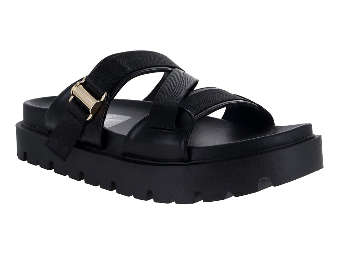 Sandalias negras de plataforma con suela dentada y correas ajustables con hebilla dorada.