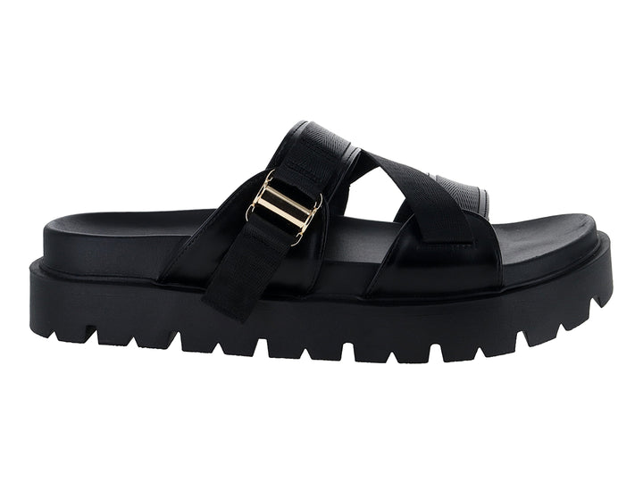 Sandalias negras de plataforma con suela dentada y correas ajustables con hebilla dorada.