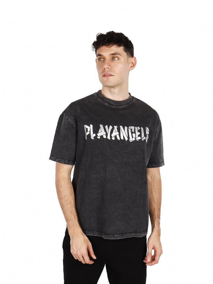 Hombre vistiendo playera oversize color negro con estampado frontal blanco.
