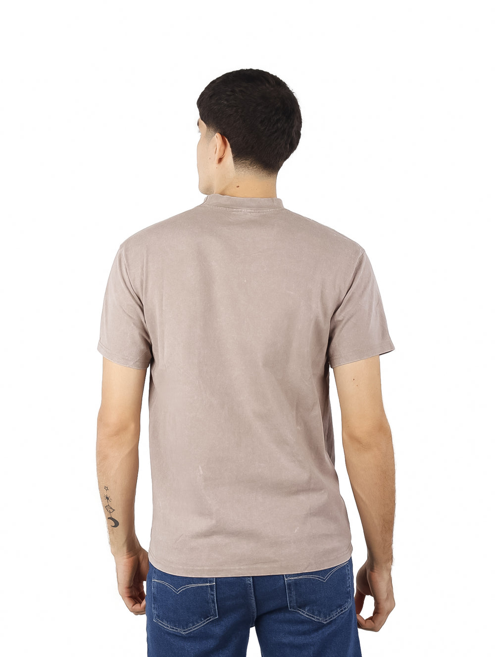 Hombre vistiendo playera oversize de color café con cuello redondo y manga corta.