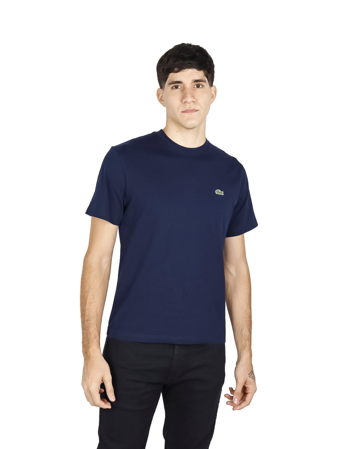 Hombre vistiendo una camiseta de manga corta color navy de la marca Lacoste con cuello redondo.