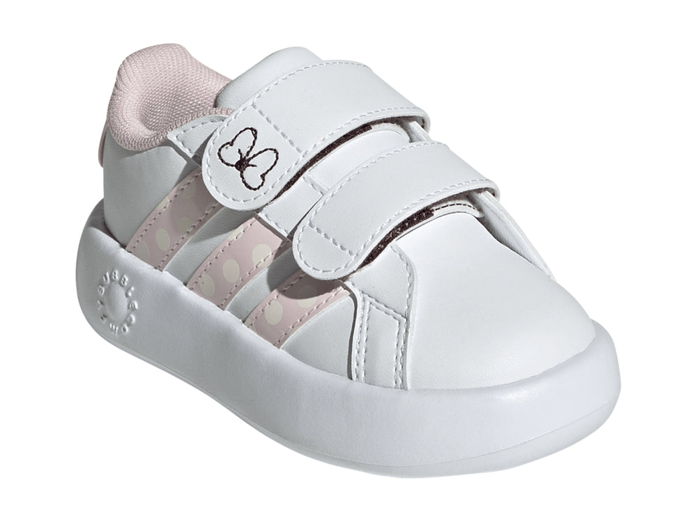 Tenis blancos Adidas para niña con detalles en rosa, rayas de lunares y un moño en la correa.