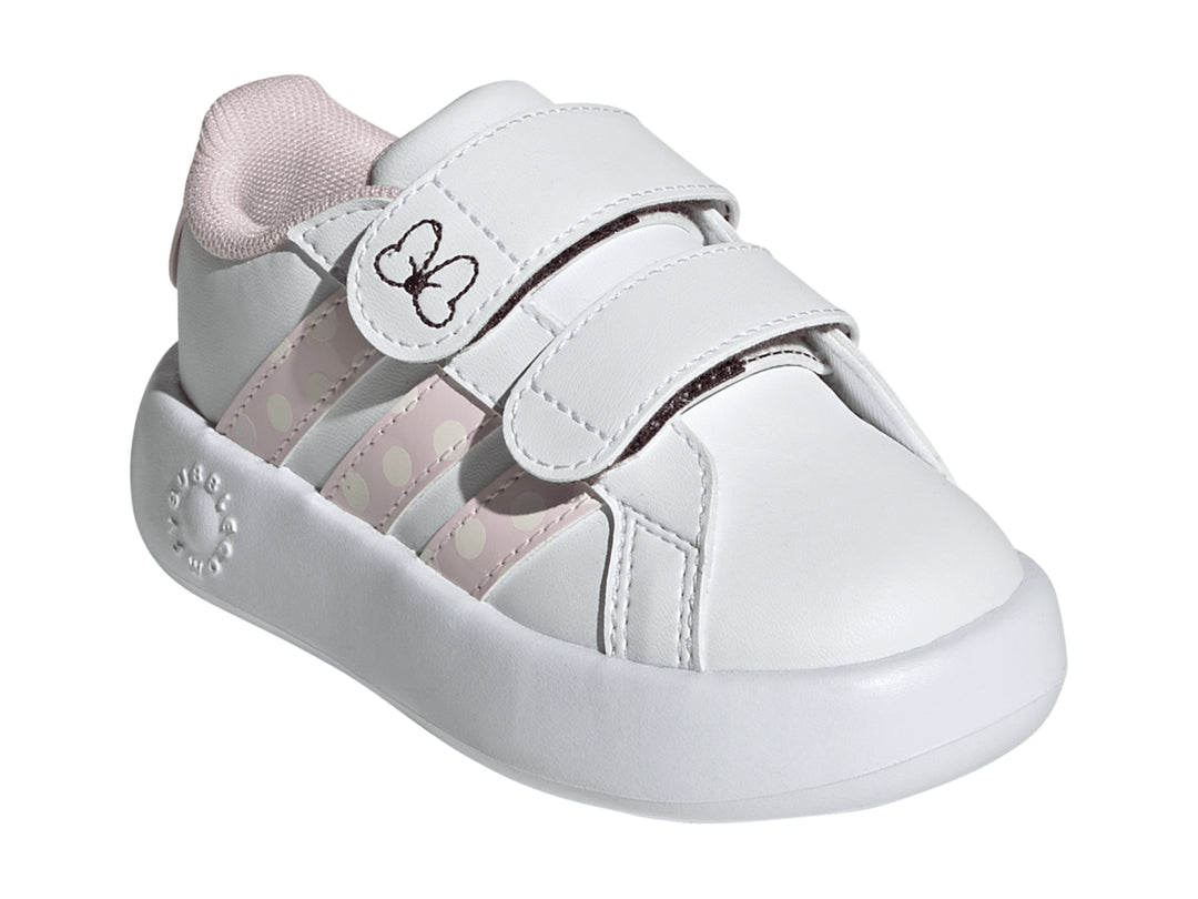 Tenis blancos Adidas para niña con detalles en rosa, rayas de lunares y un moño en la correa.