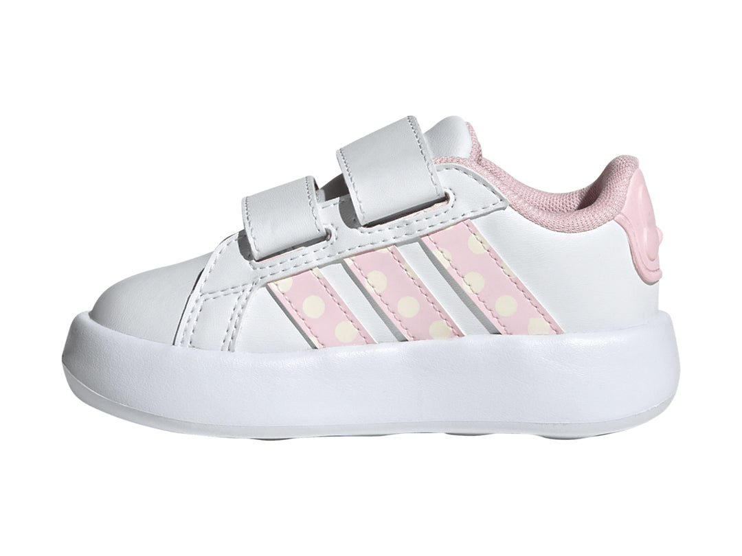 Tenis blancos Adidas para niña con detalles en rosa, rayas de lunares y un moño en la correa.