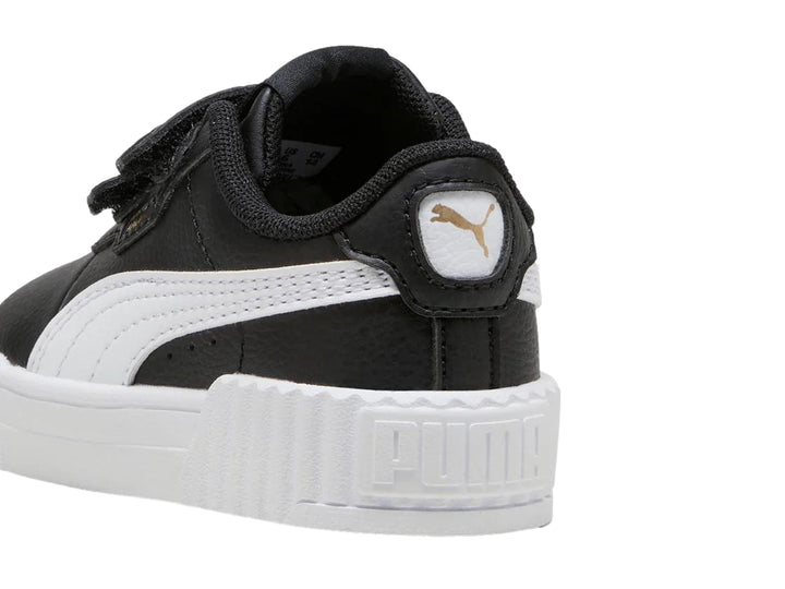 Tenis PUMA infantiles color negro con suela blanca y cierre de velcro.