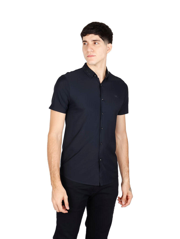 Hombre vistiendo una camisa negra de manga corta con botones y cuello.