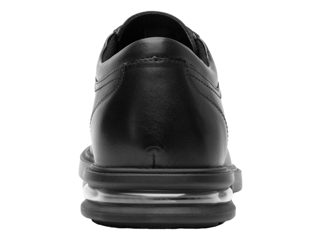 Zapato formal negro de cuero con cordones y amortiguación visible en la suela.