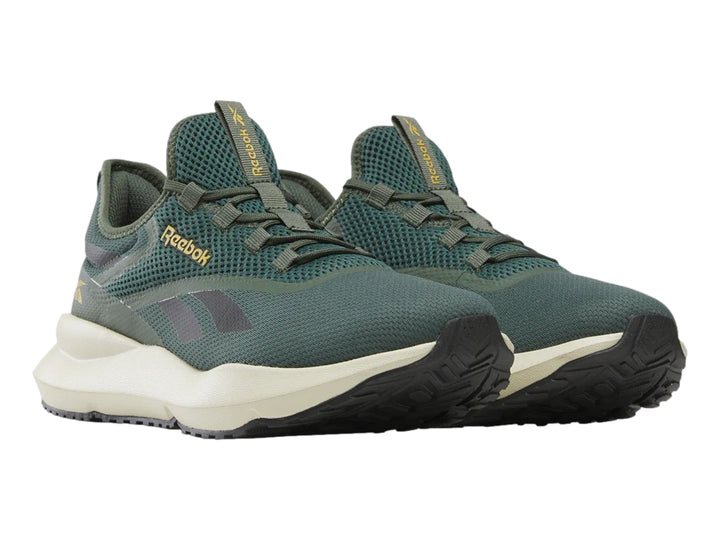 Tenis deportivos Reebok color verde con suela color crema y detalles en gris.
