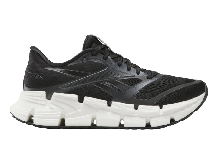 Tenis deportivos Reebok Floatride Energy en color negro con suela blanca robusta.