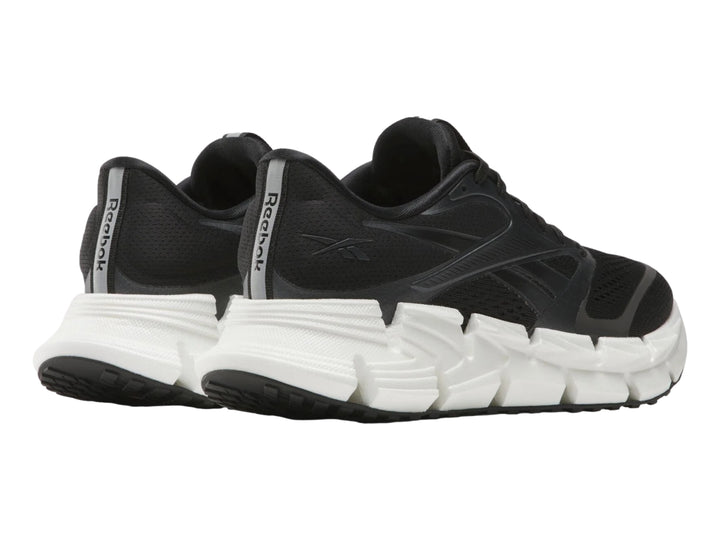 Tenis deportivos Reebok Floatride Energy en color negro con suela blanca robusta.