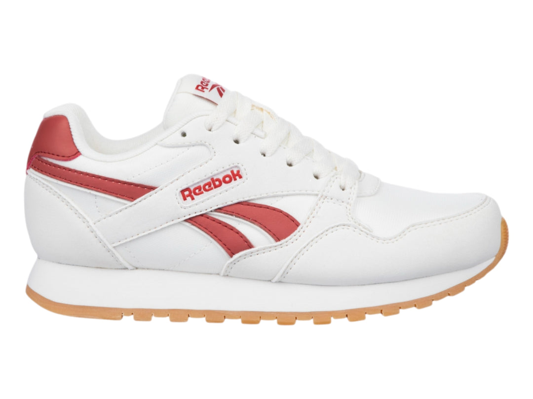Tenis Reebok color blanco con detalles en rojo y suela de goma color café.