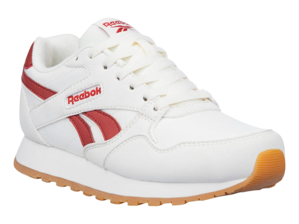 Tenis Reebok color blanco con detalles en rojo y suela de goma color café.