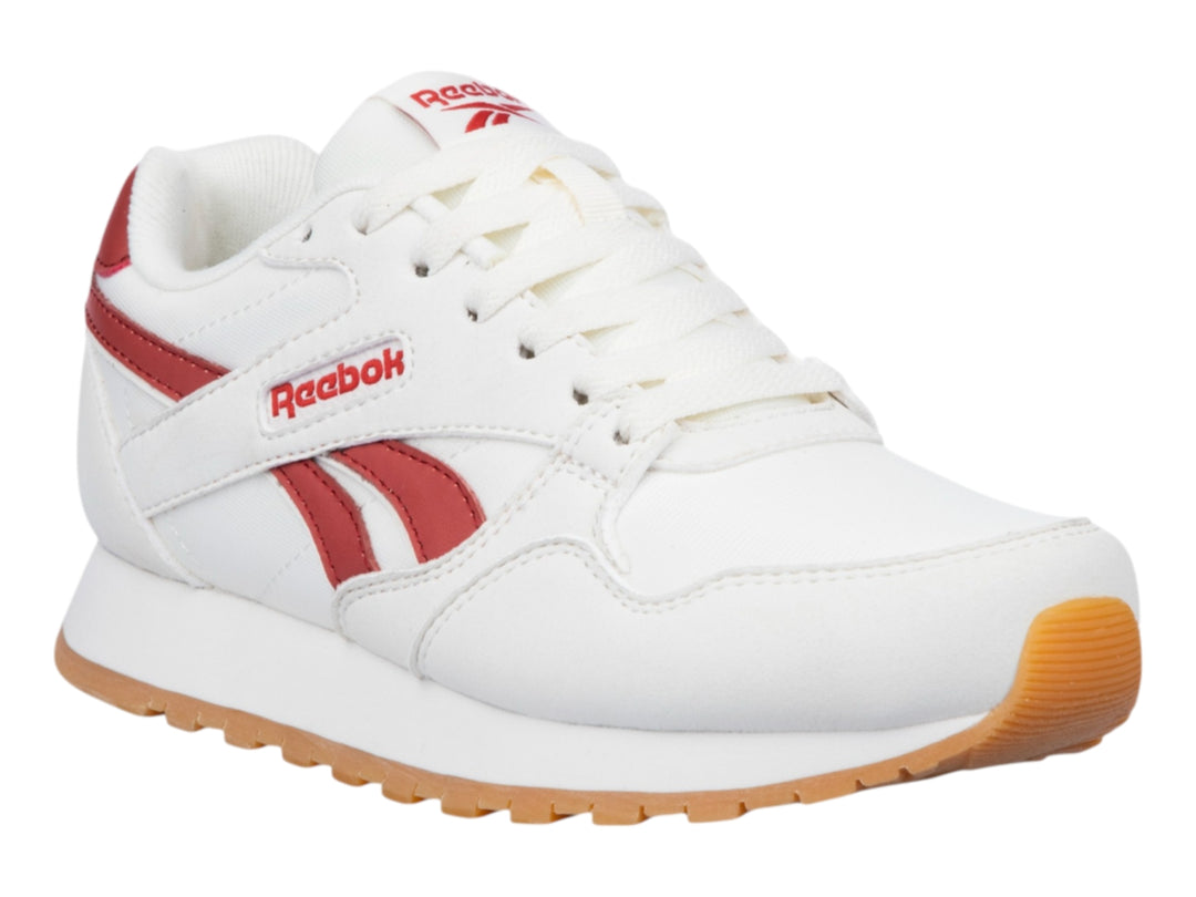 Tenis Reebok color blanco con detalles en rojo y suela de goma color café.