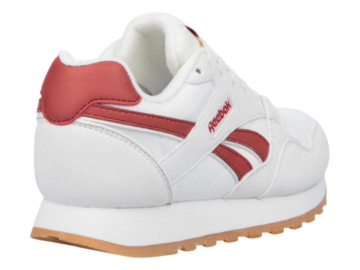 Tenis Reebok color blanco con detalles en rojo y suela de goma color café.