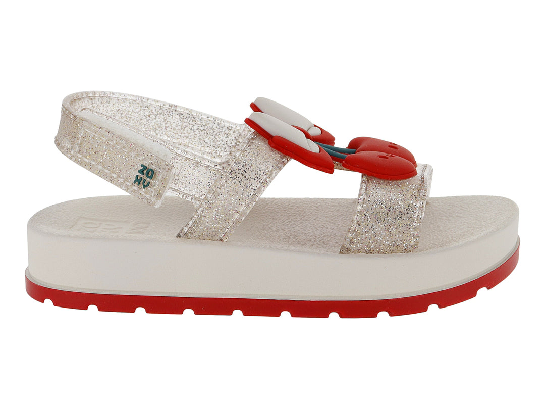 Sandalias blancas para niña con acabado brillante, plataforma blanca y suela roja con detalle decorativo rojo.