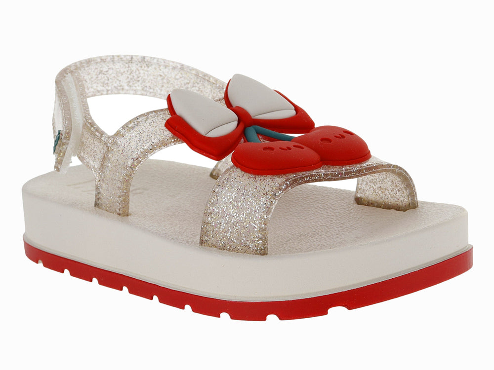 Sandalias blancas para niña con acabado brillante, plataforma blanca y suela roja con detalle decorativo rojo.