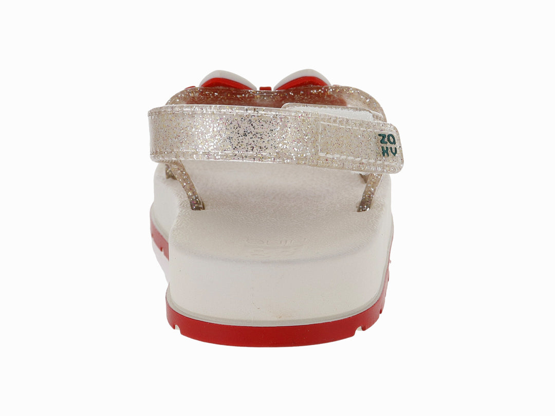 Sandalias blancas para niña con acabado brillante, plataforma blanca y suela roja con detalle decorativo rojo.