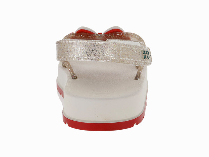 Sandalias blancas para niña con acabado brillante, plataforma blanca y suela roja con detalle decorativo rojo.