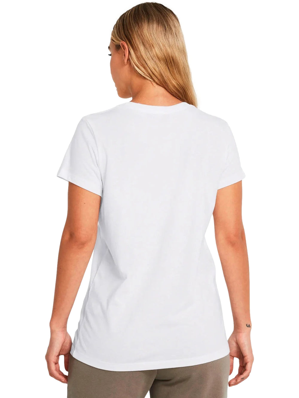 Mujer vistiendo una camiseta blanca de manga corta con el logo de Under Armour en color negro en el pecho.